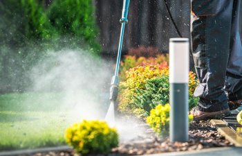 A Pressure Washing Force employee providing residential pressure washing services.