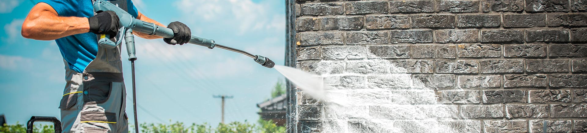 A specialist performing professional brick wall pressure washing.