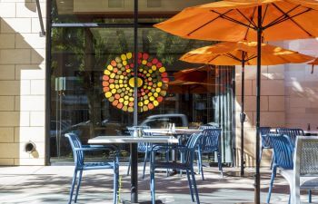 Tables and chairs in front of cafe.